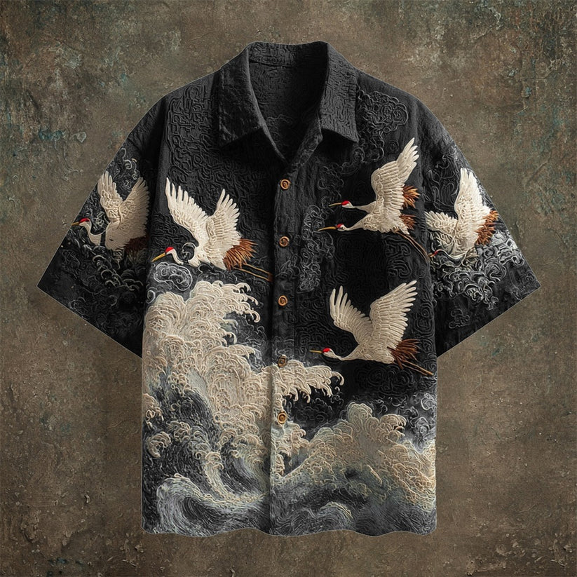 Black short-sleeve shirt with Japanese-inspired crane and ocean-wave artwork.